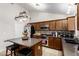 Well lit kitchen with an island, dark countertops, stainless steel appliances, and dark cabinets at 1207 E Sequoia Dr, Phoenix, AZ 85024