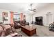 Cozy living room featuring plush carpeting, a ceiling fan, and ample seating at 1207 E Sequoia Dr, Phoenix, AZ 85024