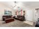Comfortable living room with plush carpeting, ceiling fan, and ample seating at 1207 E Sequoia Dr, Phoenix, AZ 85024