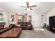 Bright living room with plush carpeting, ample seating, and neutral wall paint at 1207 E Sequoia Dr, Phoenix, AZ 85024