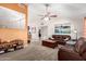 Spacious living room with vaulted ceilings, ceiling fan, plush carpeting, and a comfortable leather sofa at 1207 E Sequoia Dr, Phoenix, AZ 85024