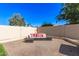 Relaxing outdoor patio with stylish seating, brick pavers, and privacy wall in a beautifully landscaped backyard at 1207 E Sequoia Dr, Phoenix, AZ 85024