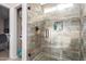 Bathroom shower featuring gorgeous decorative tile, a glass enclosure, and a shower niche for toiletries at 1207 E Sequoia Dr, Phoenix, AZ 85024