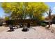 Spacious backyard with desert landscaping, a fire pit, and seating area for outdoor enjoyment at 18436 W Shasta St, Goodyear, AZ 85338