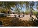 Backyard seating area with mature shade tree providing a relaxing outdoor space at 18436 W Shasta St, Goodyear, AZ 85338