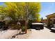 Landscaped backyard with mature trees, spa, and paver patio perfect for outdoor living at 18436 W Shasta St, Goodyear, AZ 85338
