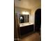 Bathroom featuring double sinks, vanity with tile flooring and a mirror reflecting the bedroom at 18436 W Shasta St, Goodyear, AZ 85338