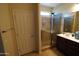 Bathroom featuring glass shower, double sinks, vanity and tile flooring at 18436 W Shasta St, Goodyear, AZ 85338