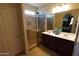Bathroom featuring glass shower, double sinks, vanity and tile flooring at 18436 W Shasta St, Goodyear, AZ 85338