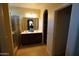 Bathroom featuring double sinks, vanity, glass shower and tile flooring at 18436 W Shasta St, Goodyear, AZ 85338