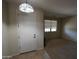 Foyer with tile floor and decorative light fixture leading into a carpeted living area at 18436 W Shasta St, Goodyear, AZ 85338