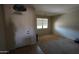 Foyer with tile floor and decorative light fixture leading into a carpeted living area at 18436 W Shasta St, Goodyear, AZ 85338