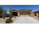 Beautiful desert home showcasing well-manicured landscaping, a two-car garage, and a welcoming entrance at 18436 W Shasta St, Goodyear, AZ 85338