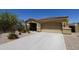 Beautiful desert home showcasing a two-car garage, desert landscaping, and a welcoming entrance at 18436 W Shasta St, Goodyear, AZ 85338