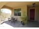 Charming front porch with outdoor seating and vibrant green potted plant at 18436 W Shasta St, Goodyear, AZ 85338