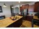 Beautiful kitchen with stainless steel appliances, granite countertops, and an island with a sink at 18436 W Shasta St, Goodyear, AZ 85338