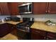 Kitchen featuring stainless steel appliances, rich wood cabinets and granite countertops at 18436 W Shasta St, Goodyear, AZ 85338