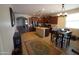 Expansive kitchen with a dining area, stainless steel appliances, and warm lighting fixtures at 18436 W Shasta St, Goodyear, AZ 85338