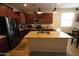 Spacious kitchen with stainless steel appliances, a center island, and stylish pendant lighting at 18436 W Shasta St, Goodyear, AZ 85338
