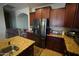 Kitchen featuring stainless steel appliances, rich wood cabinets and granite countertops at 18436 W Shasta St, Goodyear, AZ 85338
