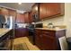 Well-equipped kitchen featuring granite countertops, stainless steel appliances, and warm wood cabinetry at 18436 W Shasta St, Goodyear, AZ 85338