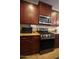 Close-up of the kitchen featuring stainless steel appliances and abundant counter space at 18436 W Shasta St, Goodyear, AZ 85338