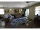 Cozy living room featuring comfortable seating, natural light, and a stylish area rug at 18436 W Shasta St, Goodyear, AZ 85338