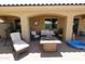 A covered outdoor patio with seating, outdoor furniture and tile flooring at 18436 W Shasta St, Goodyear, AZ 85338