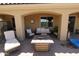 Outdoor living space with comfortable furniture and a stylish fire pit table, perfect for relaxation at 18436 W Shasta St, Goodyear, AZ 85338