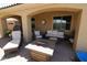 Covered patio area with comfortable seating and stylish decor for outdoor relaxation at 18436 W Shasta St, Goodyear, AZ 85338