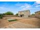 Large backyard with patio, small patch of grass, and access to the house at 21033 N Alexis Ave, Maricopa, AZ 85138