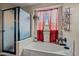 This bathroom features a large tub, shower and natural light at 21033 N Alexis Ave, Maricopa, AZ 85138