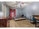 Cozy bedroom with carpeted floors, a ceiling fan, and a comfortable bed next to a writing desk at 21033 N Alexis Ave, Maricopa, AZ 85138