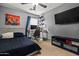 This bedroom features gray walls, ceiling fan, a desk and a large TV mounted on the wall at 21033 N Alexis Ave, Maricopa, AZ 85138