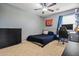 Spacious bedroom with carpeted floors, ceiling fan, black dresser, desk and comfortable bed at 21033 N Alexis Ave, Maricopa, AZ 85138