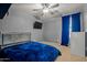 Modern bedroom featuring carpeted floors, a ceiling fan, and a comfortable bed at 21033 N Alexis Ave, Maricopa, AZ 85138