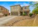 Two-story home with a neutral color scheme, a two-car garage, and low-maintenance desert landscaping at 21033 N Alexis Ave, Maricopa, AZ 85138