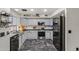 This stylish kitchen features light grey cabinets, black countertops and stainless steel appliances at 21033 N Alexis Ave, Maricopa, AZ 85138