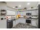 Bright kitchen with stainless steel appliances, stylish backsplash, and grey cabinets and stylish decorations at 21033 N Alexis Ave, Maricopa, AZ 85138