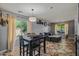 The dining and living area features tile floors, ample natural light, and neutral wall colors at 21033 N Alexis Ave, Maricopa, AZ 85138