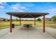 Community picnic area offers shaded seating, lush green space, and open views at 21033 N Alexis Ave, Maricopa, AZ 85138