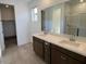 Bathroom featuring double sinks, vanity, and a glass-enclosed shower, providing a spa-like experience at 25146 W Wayland Dr, Buckeye, AZ 85326