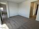 Spacious bedroom with plush carpeting and natural light, with an open doorway to the bathroom at 25146 W Wayland Dr, Buckeye, AZ 85326