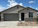Charming single-story home featuring a two-car garage and desert landscaping for low maintenance at 25146 W Wayland Dr, Buckeye, AZ 85326