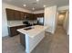 Modern kitchen with stainless steel appliances, center island, quartz countertops, and ample cabinet space at 25146 W Wayland Dr, Buckeye, AZ 85326
