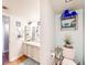 Well-lit bathroom featuring a toilet, a vanity sink, and wall shelves for storage at 3002 N 70Th St # 120, Scottsdale, AZ 85251