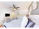 Light filled bedroom showcasing a ceiling fan, decorative wall art, and a comfortable bed setup at 3002 N 70Th St # 120, Scottsdale, AZ 85251