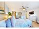 Light-filled bedroom with a ceiling fan, dresser, and a comfortable bed with soft bedding at 3002 N 70Th St # 120, Scottsdale, AZ 85251