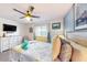 Comfortable bedroom with a ceiling fan, window, dresser, and cozy bed at 3002 N 70Th St # 120, Scottsdale, AZ 85251