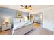 Bright bedroom with a ceiling fan, nightstand, closet, and a comfortable queen bed at 3002 N 70Th St # 120, Scottsdale, AZ 85251